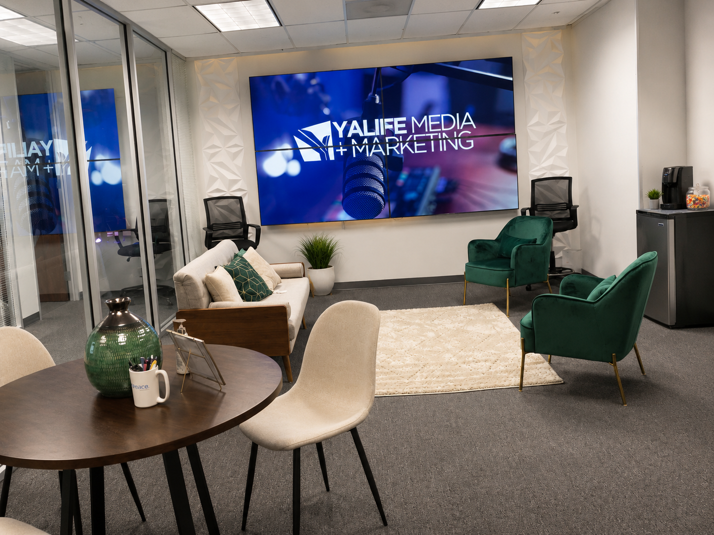 The YaLife Media & Marketing office lounge in Houston with the brand video wall